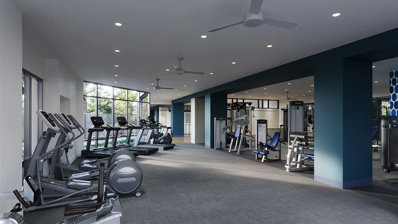 A modern and spacious gym interior equipped with various cardiovascular machines, including treadmills and ellipticals, along with a selection of weight training equipment, all under bright lighting for an inviting workout environment.
